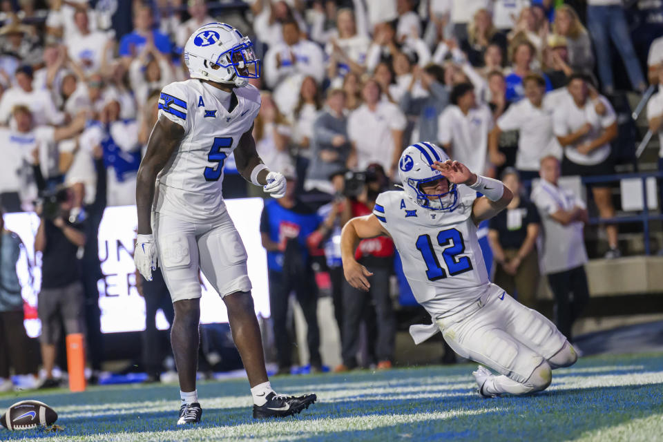 Brigham Young wide receiver Darius Lassiter (5) and quarterback Jake Retzlaff (12) celebrate a touchdown in the end zone during an NCAA football game against Kansas St., on Saturday, Sept. 21, 2024 in Provo, Utah. (AP Photo/Tyler Tate)