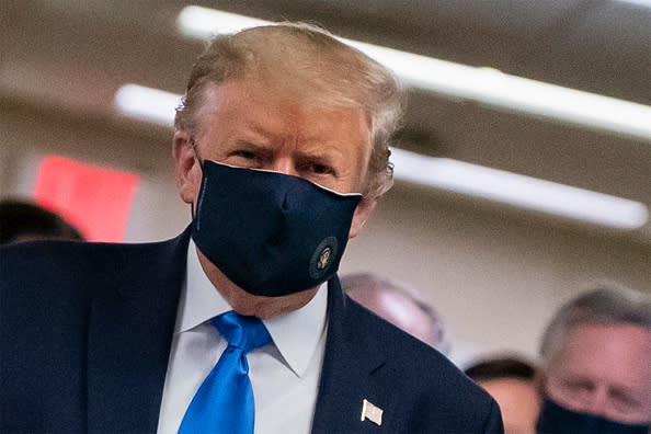 US President Donald Trump wears a mask as he visits Walter Reed National Military Medical Center in Bethesda, Maryland.