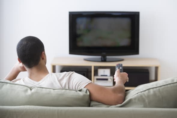 USA, New Jersey, Jersey City, Man watching tv at home