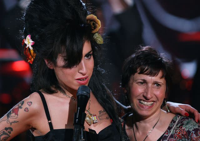 <p>Peter Macdiarmid/Getty</p> Amy Winehouse hugs her mother Janis Winehouse after accepting a Grammy Award at the Riverside Studios for the 50th Grammy Awards ceremony on February 10, 2008 in London, England.