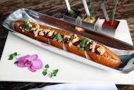 <p>Ditch the street hot dogs sitting in suspicious-looking water and try one that’s worth $69 instead. The all-beef hot dog at <a href="https://www.tripadvisor.com/Restaurant_Review-g60763-d423867-Reviews-Serendipity_3-New_York_City_New_York.html" rel="nofollow noopener" target="_blank" data-ylk="slk:Serendipity;elm:context_link;itc:0;sec:content-canvas" class="link ">Serendipity</a> is served on a pretzel bun, topped with foie gras, Vidalia onions, and black truffles. And because they didn’t want the luxury to end, the hot dog is grilled in truffle oil.</p>