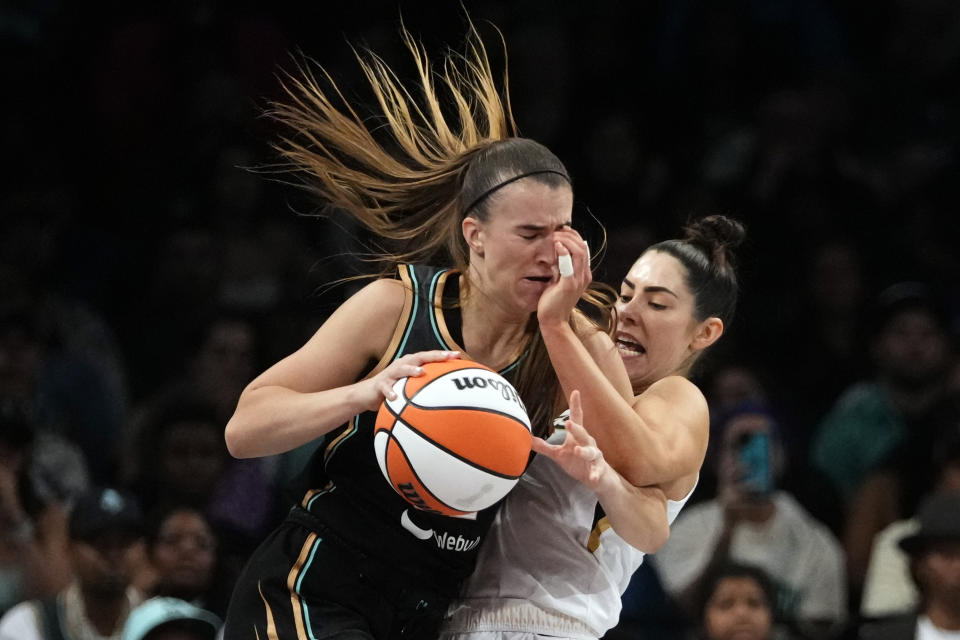 Las Vegas Aces' Kelsey Plum, right, defends New York Liberty's Sabrina Ionescu during the second half in Game 4 of a WNBA basketball final playoff series Wednesday, Oct. 18, 2023, in New York. The Aces won 70-69. (AP Photo/Frank Franklin II)