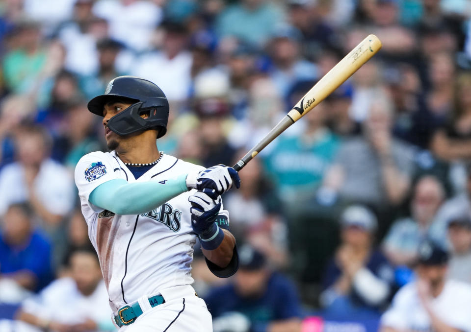 Seattle Mariners' Julio Rodriguez follows through on an RBI single to score Jarred Kelenic against the Washington Nationals during the fourth inning of a baseball game Monday, June 26, 2023, in Seattle. (AP Photo/Lindsey Wasson)