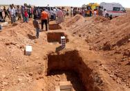 Three graves that were dug for the two Syrian toddlers and their mother, all of whom drowned as they were trying to reach Greece, are pictured during their funeral in the Syrian border town of Kobani September 4, 2015. The toddlers, including three-year-old Aylan Kurdi, were laid to rest in the Syrian town of Kobani on Friday, a Reuters witness said. Abdullah Kurdi, their father, wept as their bodies were buried alongside each other in the "Martyrs' Ceremony" in the predominantly Kurdish town of Kobani, also known as Ayn al-Arab, near at the border with Turkey. REUTERS/Rodi Said