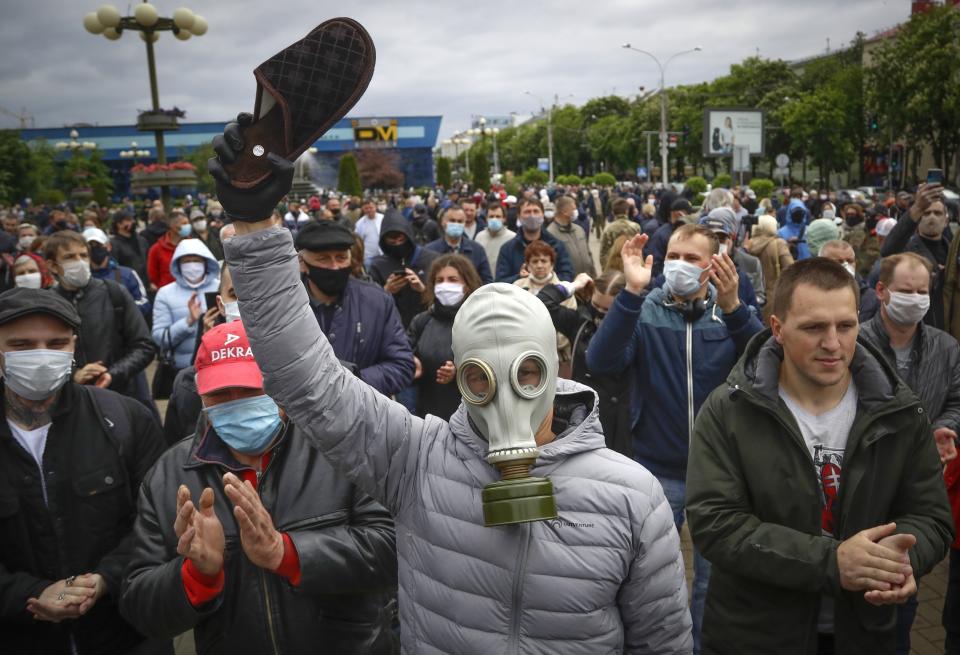 FILE In this file photo taken on Sunday, May 31, 2020, A man, wearing a mask to protect against coronavirus, attends a rally to support for potential presidential candidates in the upcoming presidential elections in Minsk, Belarus. Lukashenko refused to impose any restrictions, making Belarus the only country in Europe to continue playing professional soccer games with fans in the stands while the outbreak was in full swing. Religious service and other mass gatherings went on unimpeded, and the nation had a massive military parade in May to mark the 75th anniversary of the Nazi defeat in World War II. (AP Photo/Sergei Grits, File)