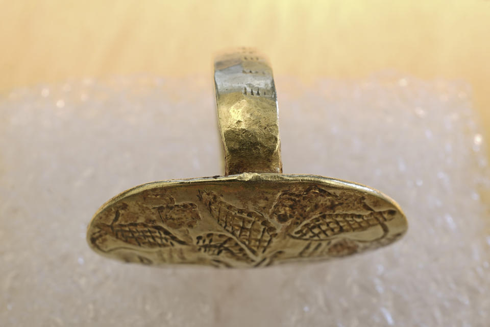 This undated photo provided by the Greek Culture Ministry on Friday, May 20, 2022, shows a gold Mycenaean-era ring which was returned by Swedish officials who provided full assistance with documenting the artifact and its provenance. A more than 3,000-year-old gold signet ring that was stolen from an Aegean Sea island in World War II, crossed the Atlantic, was bought by a Nobel Prize-winning Hungarian scientist and ended up in a Swedish museum, has found its way back to Greece. (Greek Culture Ministry via AP)