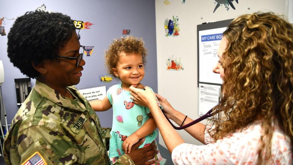 Nurse Practitioner Alison Gwinn listens to 1-year-old patient Orianna Taylor using a stethoscope during a pediatrics appointment at Kenner Army Health Clinic, Fort Lee, Va., July 29, 2019. (Lesley Atkinson/Army)