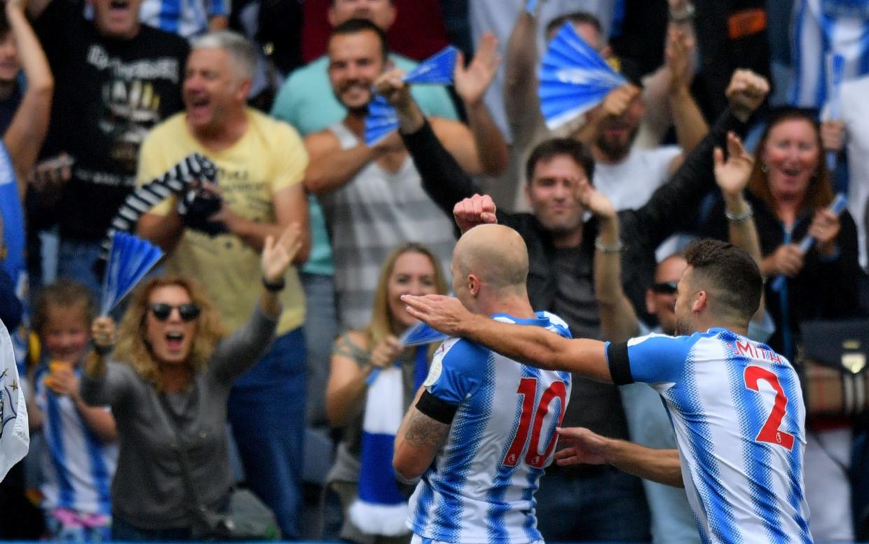 Aaron Mooy celebrates his goal with the Huddersfield fans - AFP