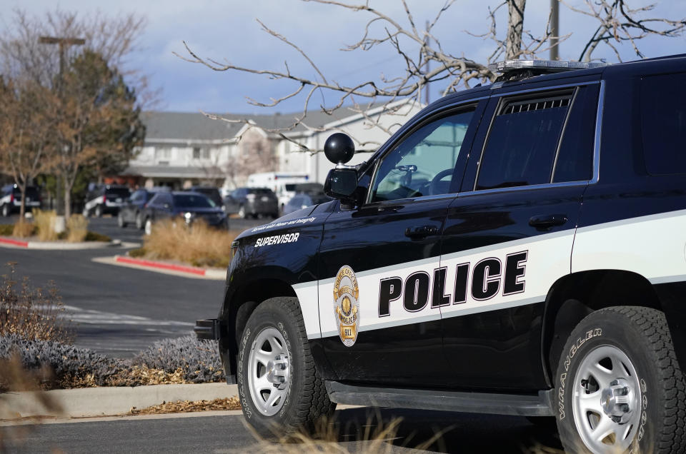 A police cruiser blocks access to the Legacy Assisted Living at Lafayette care facility, Wednesday, Feb. 3, 2021, in Lafayette, Colo. A 95-year-old resident of the assisted care home was taken into police custody Wednesday after allegedly shooting an employee at the center. (AP Photo/David Zalubowski)