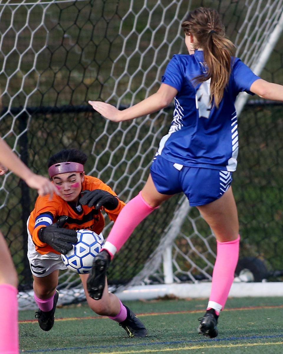 Cohasset goalie Tessa Curatola dives on the ball after making the initial save to prevent another Norwell scoring opportunity during second half action of their game against Norwell at the Norwell Clipper Community Complex on Tuesday, Oct. 11, 2022.