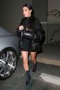 <p>In a black turtleneck minidress, puffer coat, gold pendant necklace, and Yeezy lace-up ankle booties for a movie night in LA with her family and husband Kanye West. </p>