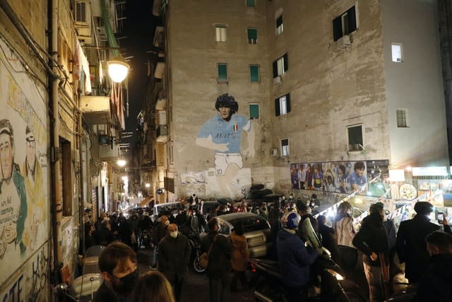 A mural of Diego Maradona adorns the wall of a building in Naples 