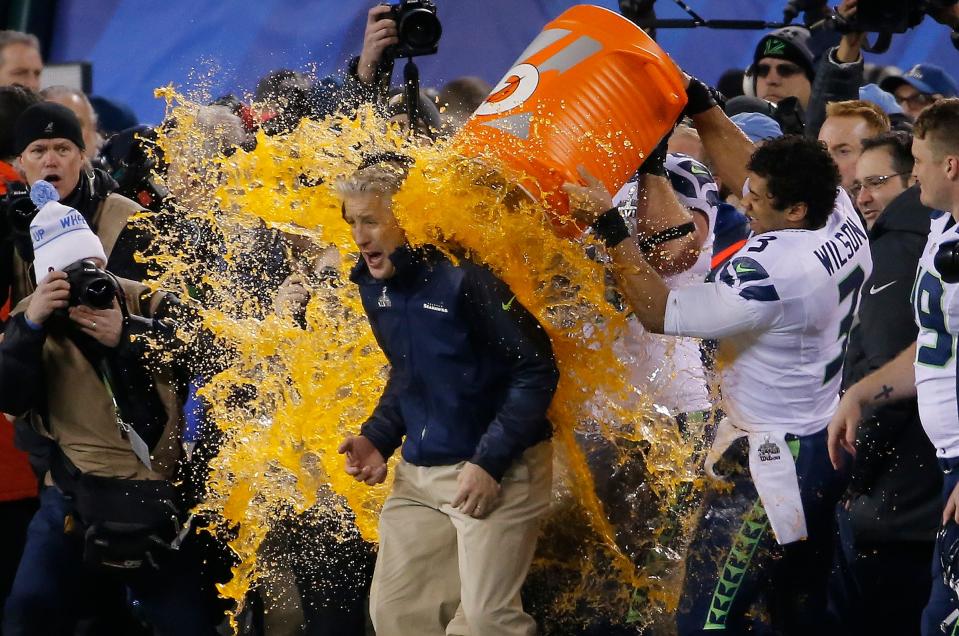 Seattle Seahawks quarterback Russell Wilson  dumps Gatorade on coach Pete Carroll late in Super Bowl XLVIII against the Denver Broncos on Feb. 2, 2014, in East Rutherford, N.J. Seattle won 43-8. The bets are on for the color of this year's triumphant Gatorade shower.