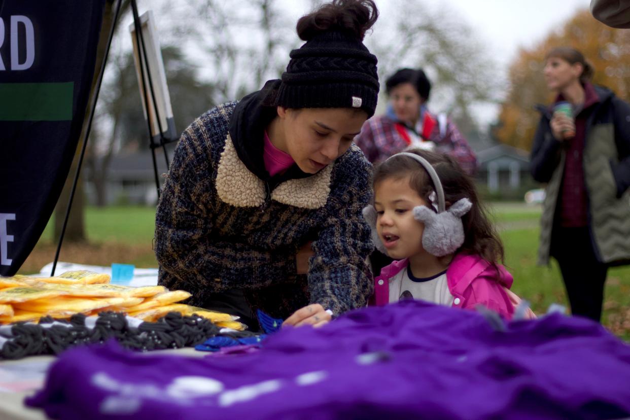 Fairfield Elementary School students pick out Ruby Bridges T-shirts, beanies and more while waiting for the commencement of the annual Ruby Bridges Walk to School Day on Tuesday.