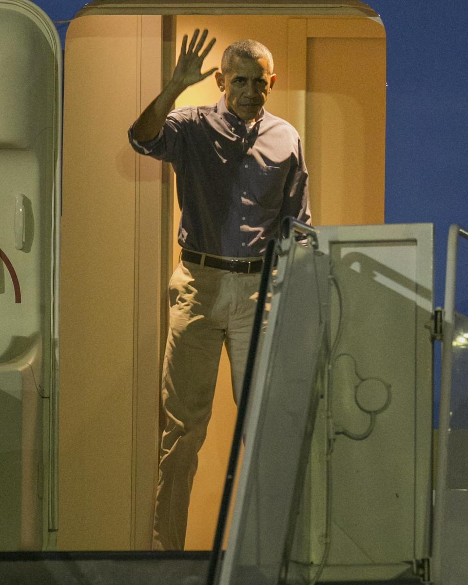 U.S. President Barack Obama waves as he exits Air Force One at Joint Base Pearl Harbor-Hickam, Friday, Dec. 16, 2016, in Honolulu. Obama and his family arrived for their annual family vacation on the island of Oahu. (AP Photo/Marco Garcia)