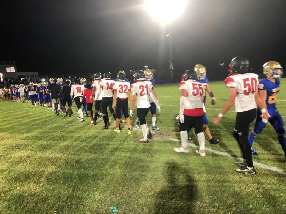 Players from Cardinal Newman and Jupiter Christian shake hands at midfield after the Kickoff Classic on Friday night in West Palm Beach.