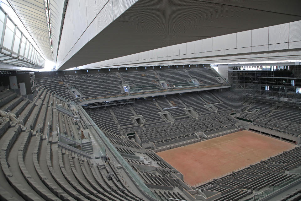 FILE - In this Wednesday, May 27, 2020 file photo, a general view of the Philippe-Chatrier tennis court with its new retractable roof during a media tour at Roland Garros stadium in Paris. Damir Dzumhur's coach called Roland Garros organizers "inhuman” on Tuesday, Sept. 22 for excluding the Bosnian player from the tournament, because the coach failed a coronavirus test. Dzumhur, a former top-30 player now ranked 114, tested negative for the virus himself but was barred from the qualifying draw for the clay major because he and his coach, Petar Popovic, shared a room in Paris. (AP Photo/Michel Euler, file)