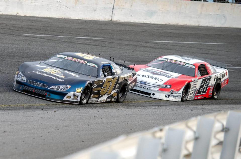 Racers make their way around the track during the 56th Annual Snowball Derby at Five Flags Speedway Sunday, December 3, 2023. Stephen Nasse (51) and Bubba Pollard (26) battle for positioning.