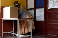 A woman stands at the voting booth during general elections in La Paz, Bolivia, Sunday, Oct. 18, 2020. (AP Photo/Juan Karita)