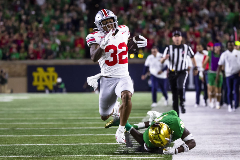 Ohio State running back TreVeyon Henderson (32) runs for a touchdown as Notre Dame safety DJ Brown falls behind him during the second half of an NCAA college football game Saturday, Sept. 23, 2023, in South Bend, Ind. (AP Photo/Michael Caterina)