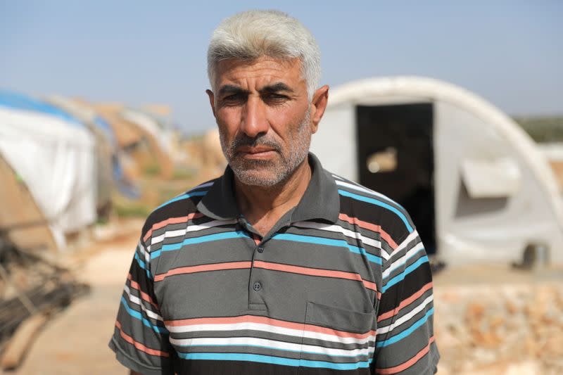 Abdelsalam Youssef, a community leader in Teh camp for internally displaced Syrians, poses for a picture in northern Idlib