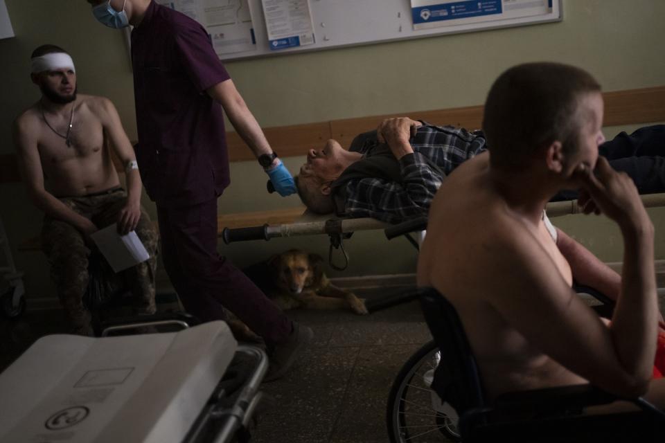 Ukrainian injured servicemen and an injured civilian wait for medical treatment in the Donetsk region, eastern Ukraine, Tuesday, June 7, 2022. The image was part of a series of images by Associated Press photographers that was a finalist for the 2023 Pulitzer Prize for Feature Photography. (AP Photo/Bernat Armangue)