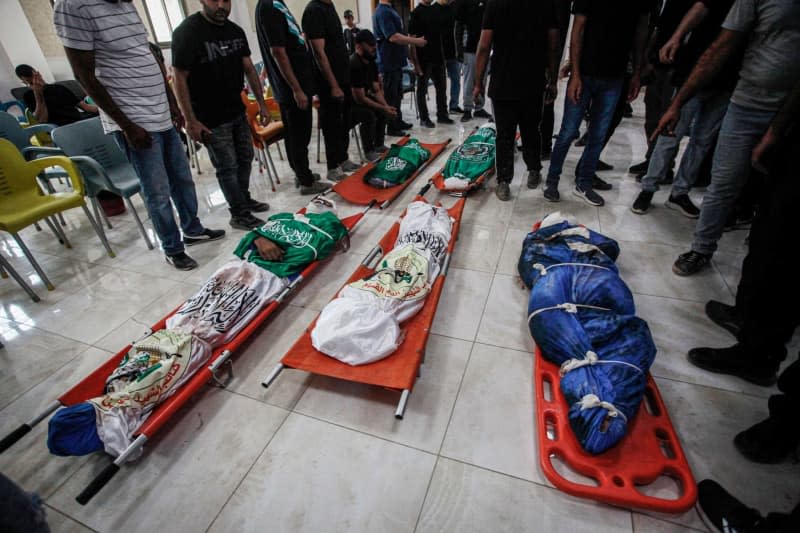 Mourners attend the funeral of Palestinians killed in an Israeli airstrike on the Tulkarem refugee camp that killed at least 18 people the day before. Mohammed Nasser/APA Images via ZUMA Press Wire/dpa