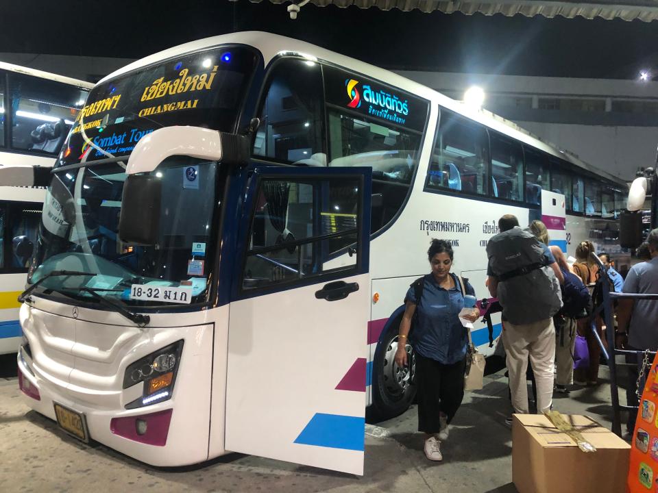 People boarding luxury bus in Thailand