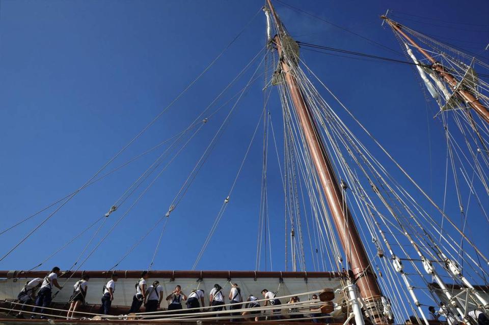 Sailors roll the sails of the Juan Sebastián de Elcano as it docks at Maurice A. Ferré Park in Miami, Florida on Wednesday, May 18, 2022.