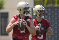 New Orleans Saints quarterbacks Derek Carr and Jake Haener (3) run through drills during NFL football practice in Metairie, La., Tuesday, May 21, 2024. (AP Photo/Gerald Herbert)