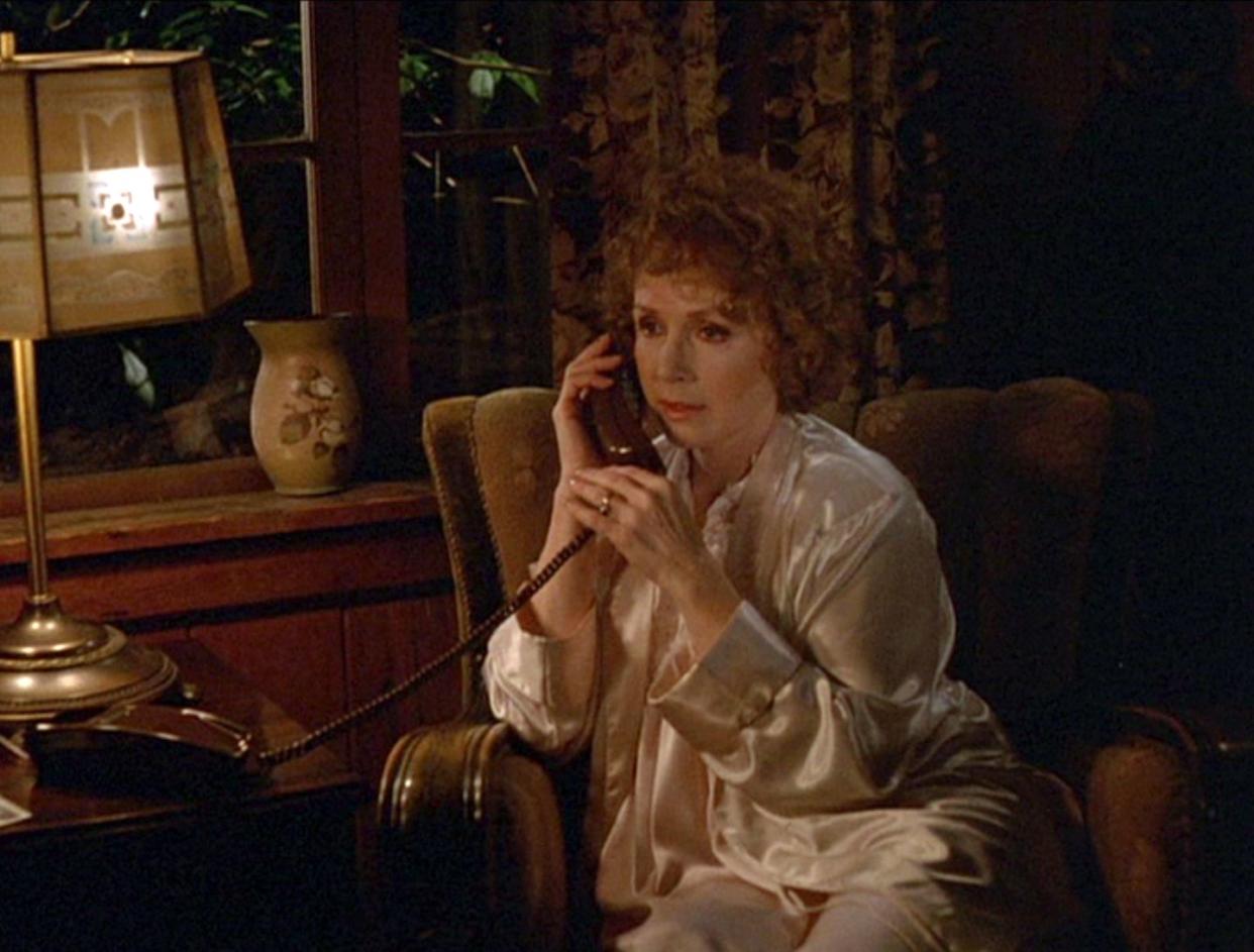 piper laurie as catherine martell, wearing a white satin robin and talking on the telephone, in the pilot episode of television series twin peaks