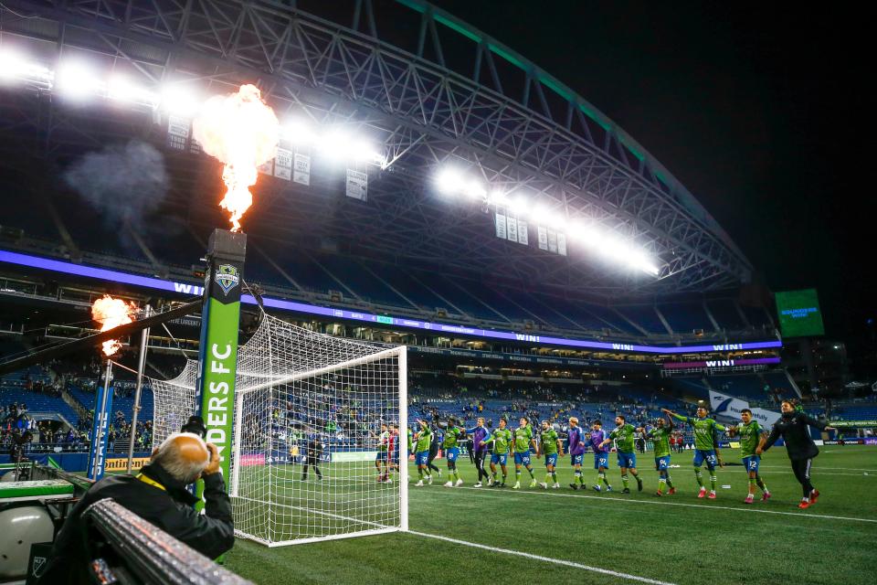 Seattle Sounders FC players celebrate a 4-1 victory against the Vancouver Whitecaps at Lumen Field. The win put the Sounders into the playoffs for the 13th consecutive season, extending an MLS record.