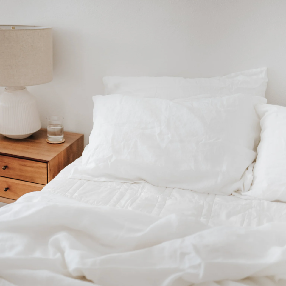 white linen bedding set on a bed