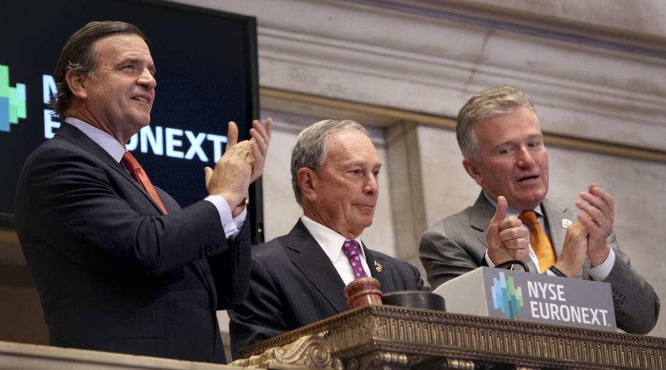 New York City Mayor Michael Bloomberg, center, gives a thumbs up after ringing in the opening bell at the New York Stock Exchange in New York, Wednesday, Oct. 31, 2012. Traffic is snarled, subways out of commission, streets flooded and power out in many parts of the city, but the New York Stock Exchange opened without hitch Wednesday after an historic two-day shutdown, courtesy of Superstrom Sandy. (AP Photo/Seth Wenig)