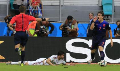 Netherlands&#39; Daryl Janmaat (R) reacts after fouling Spain&#39;s Diego Costa to give up a penalty kick. (AP)