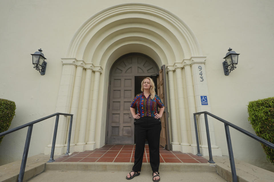 Pastor Ruth Schmidt poses for a picture at the Altadena Community Church in Altadena, Calif., on Tuesday, May 21, 2024. Schmidt, who now serves as a pastor at Claremont Presbyterian Church and is on track to be ordained in the United Church of Christ, said she would like to see faculty and staff at Fuller get the same protections as students. Fuller Theological Seminary, an evangelical school is deliberating whether to become more open to LGBTQ+ students who previously faced possible expulsion if found to be in a same-sex union. (AP Photo/Damian Dovarganes)