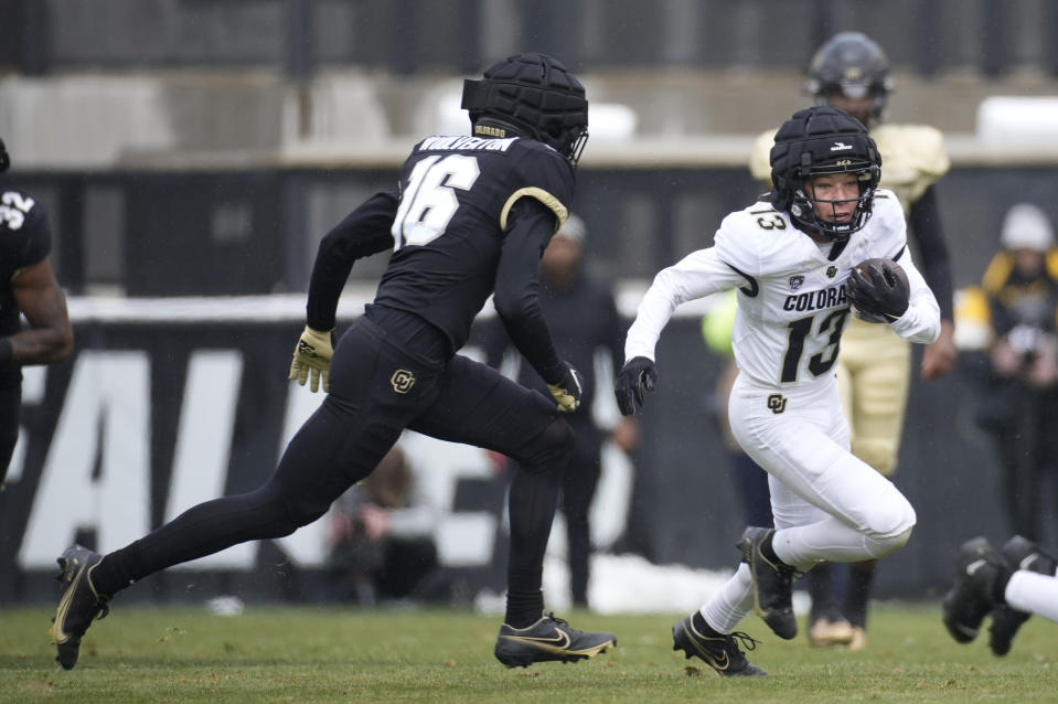 Colorado wide receiver Kaleb Mathis, right, is pursued by safety Jordan Woolverton during the first half of the team's spring NCAA college football game, Saturday, April 22, 2023, in Boulder, Colo. (AP Photo/David Zalubowski)