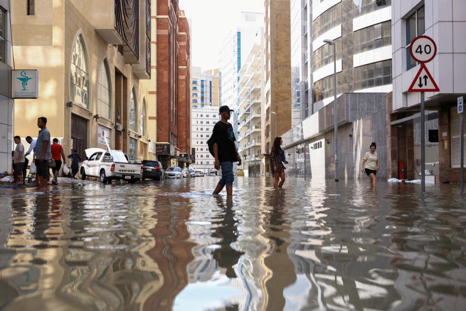 A man walks through the devastating Dubai floods (REUTERS)