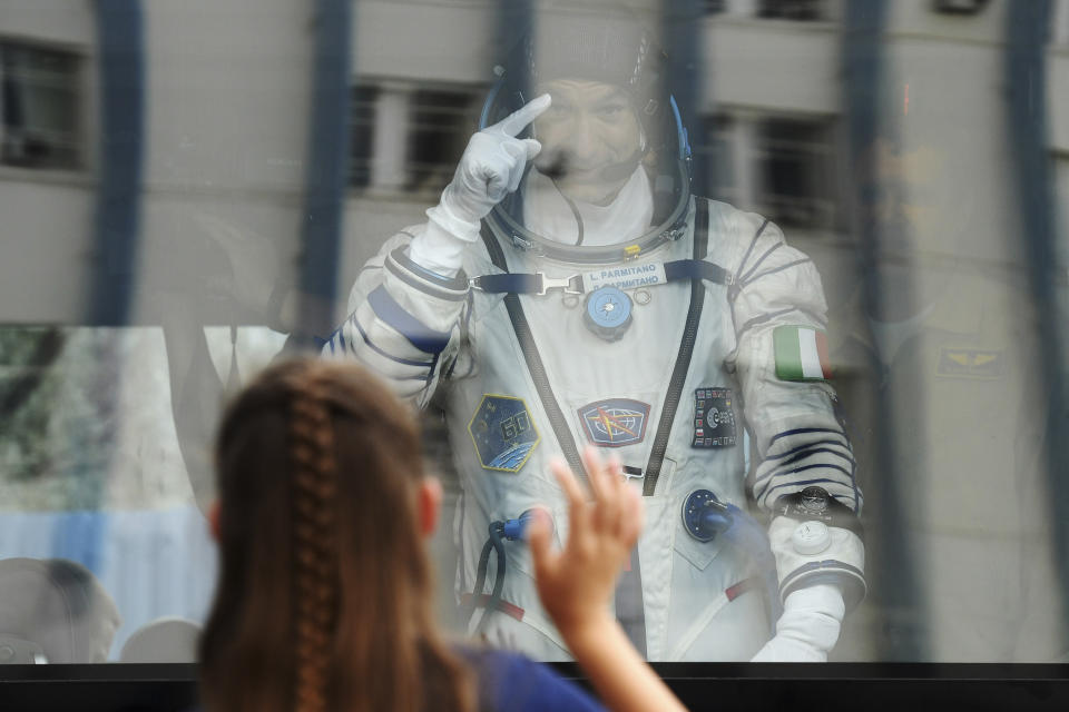 Italian astronaut Luca Parmitano, member of the main crew of the expedition to the International Space Station (ISS), gestures to his relatives from a bus prior the launch of Soyuz MS-13 space ship at the Russian leased Baikonur cosmodrome, Kazakhstan, Saturday, July 20, 2019. (AP Photo/, Pool)