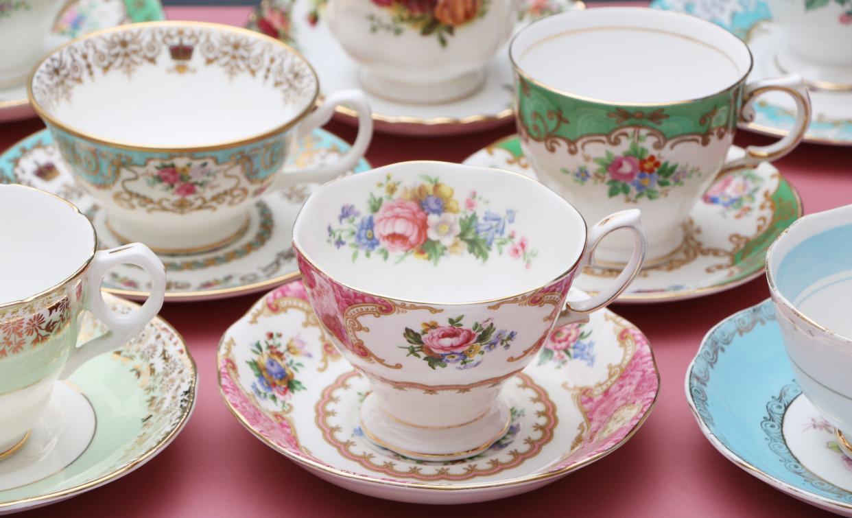 Vintage china tea cups on a dusty pink background