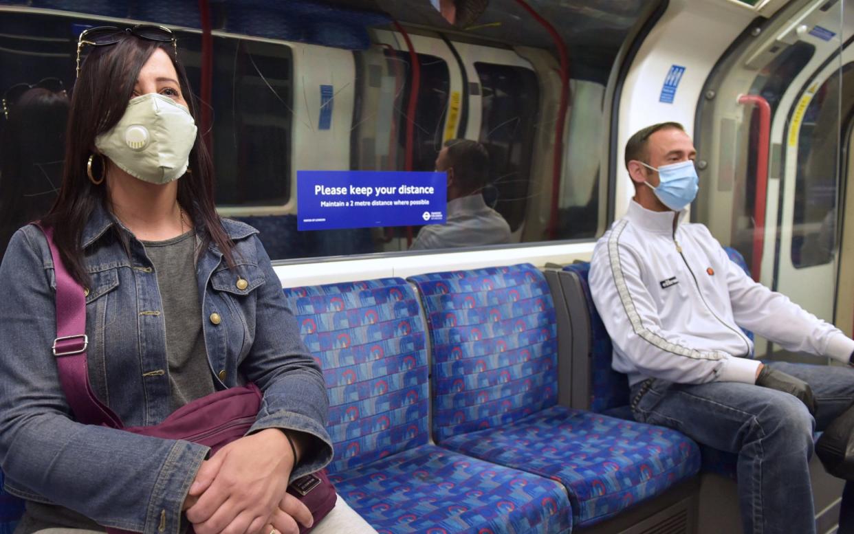 Passengers wearing face masks on the Central Line in London - Nick Ansell/PA