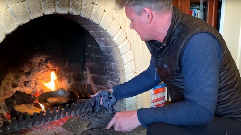 Gordon Ramsay cooks a sandwich in a fireplace