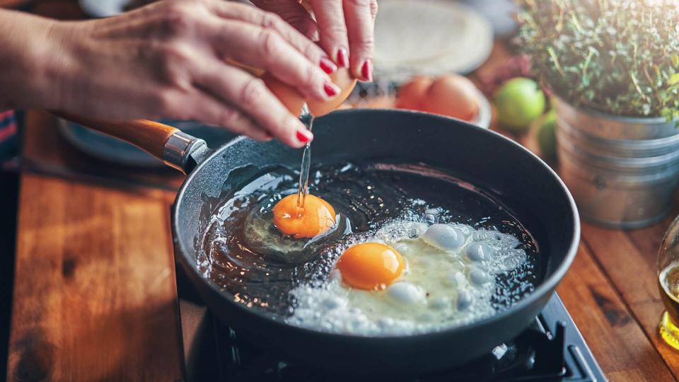 Frying Egg in a Cooking Pan in Domestic Kitchen.