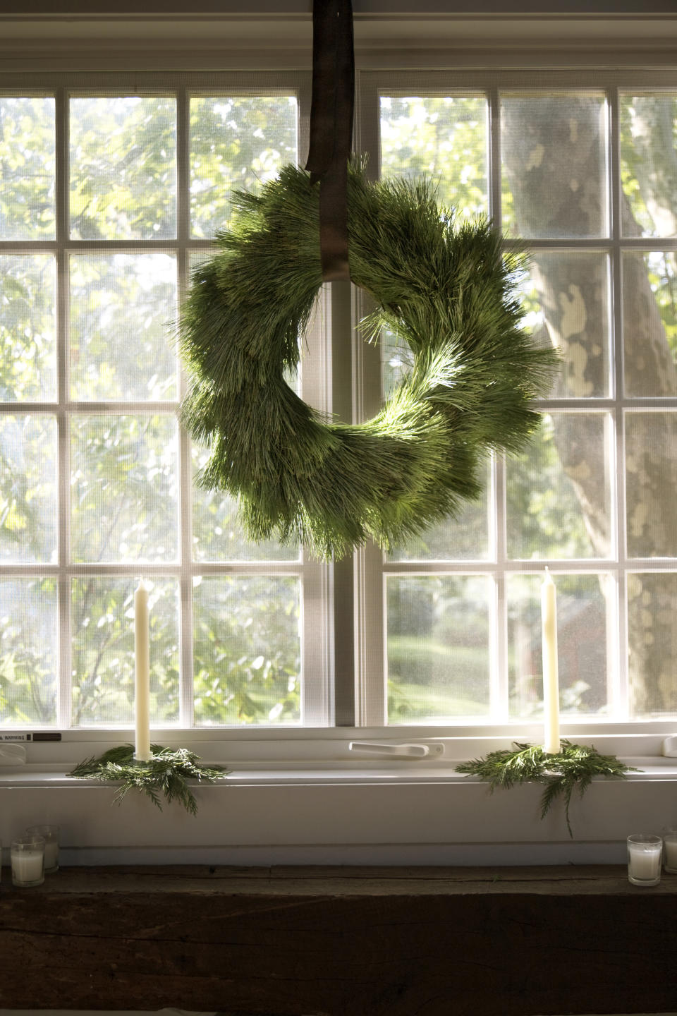 A Christmas wreath hanging in a window