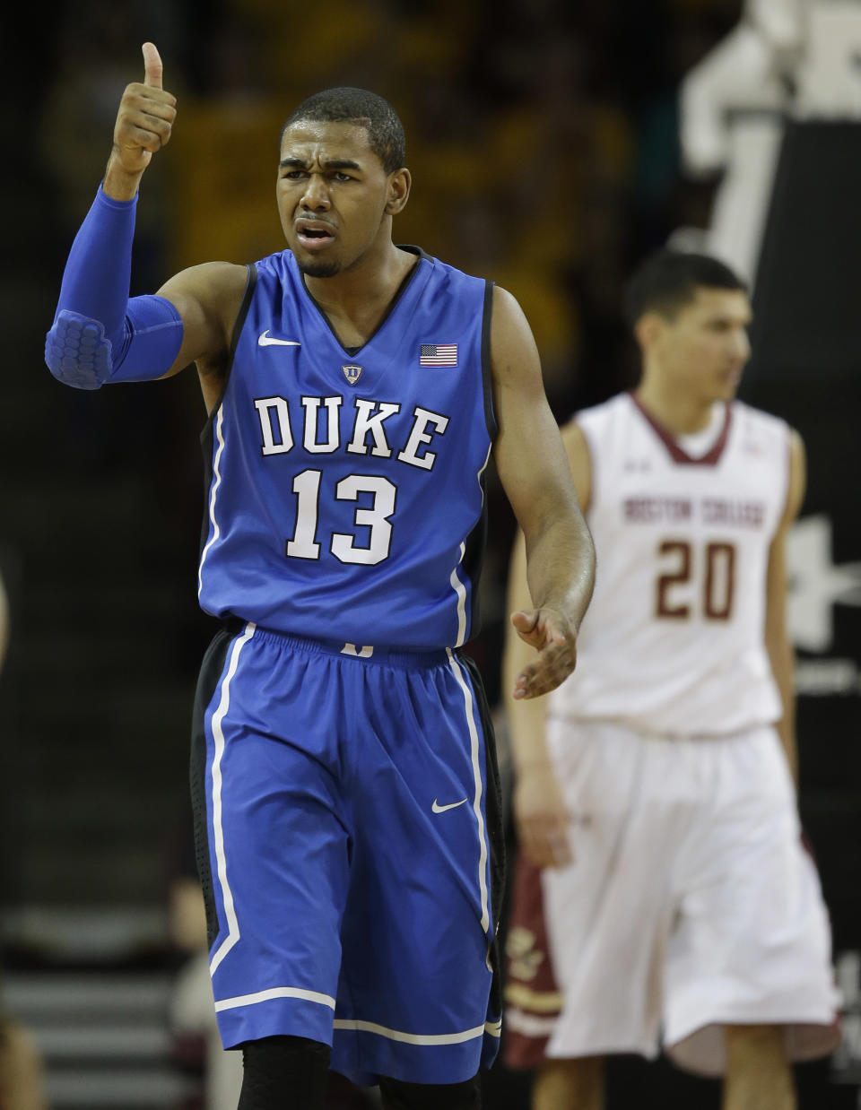 Duke guard Matt Jones (13) give a thumbs-up to his bench after scoring during the first half of their NCAA college basketball game against Boston College on the Boston College campus in Boston, Saturday, Feb. 8, 2014. (AP Photo/Stephan Savoia)