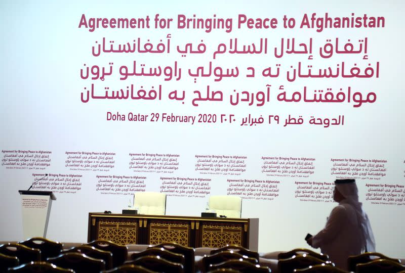 Journalist stands in the hall, ahead of an agreement signing between members of Afghanistan's Taliban delegation and U.S. officials in Doha