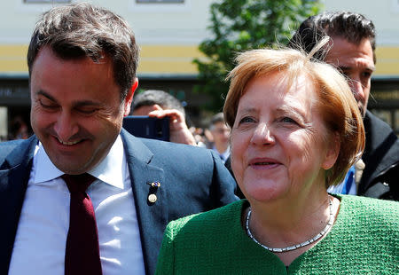 Luxembourg's Prime Minister Xavier Bettel and German Chancellor Angela Merkel react after the family photo opportunity during the informal meeting of European Union leaders in Sibiu, Romania, May 9, 2019. REUTERS/Francois Lenoir