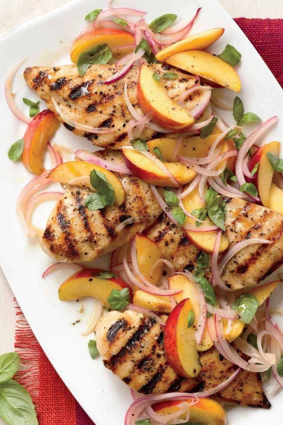 grilled chicken with nectarine red onion and basil relish on a white serving dish