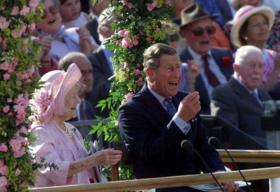 LONDON, UNITED KINGDOM - JULY 19:  Prince Charles (R) laughs with his grandmother, the Queen Mother, 19 July 2000 during the pageant celebrating her 100th birthday in Horseguards Parade, in London. (POOL)  (Photo credit should read TIM CLARKE/AFP via Getty Images)