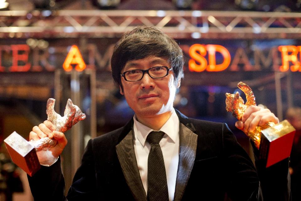 Director Diao Yinan with the Golden Bear for Best Film for the movie Black Coal, Thin Ice poses for photographers after the award ceremony at the International Film Festival Berlinale in Berlin, Saturday, Feb. 15, 2014. (AP Photo/Axel Schmidt) (AP Photo/Axel Schmidt)